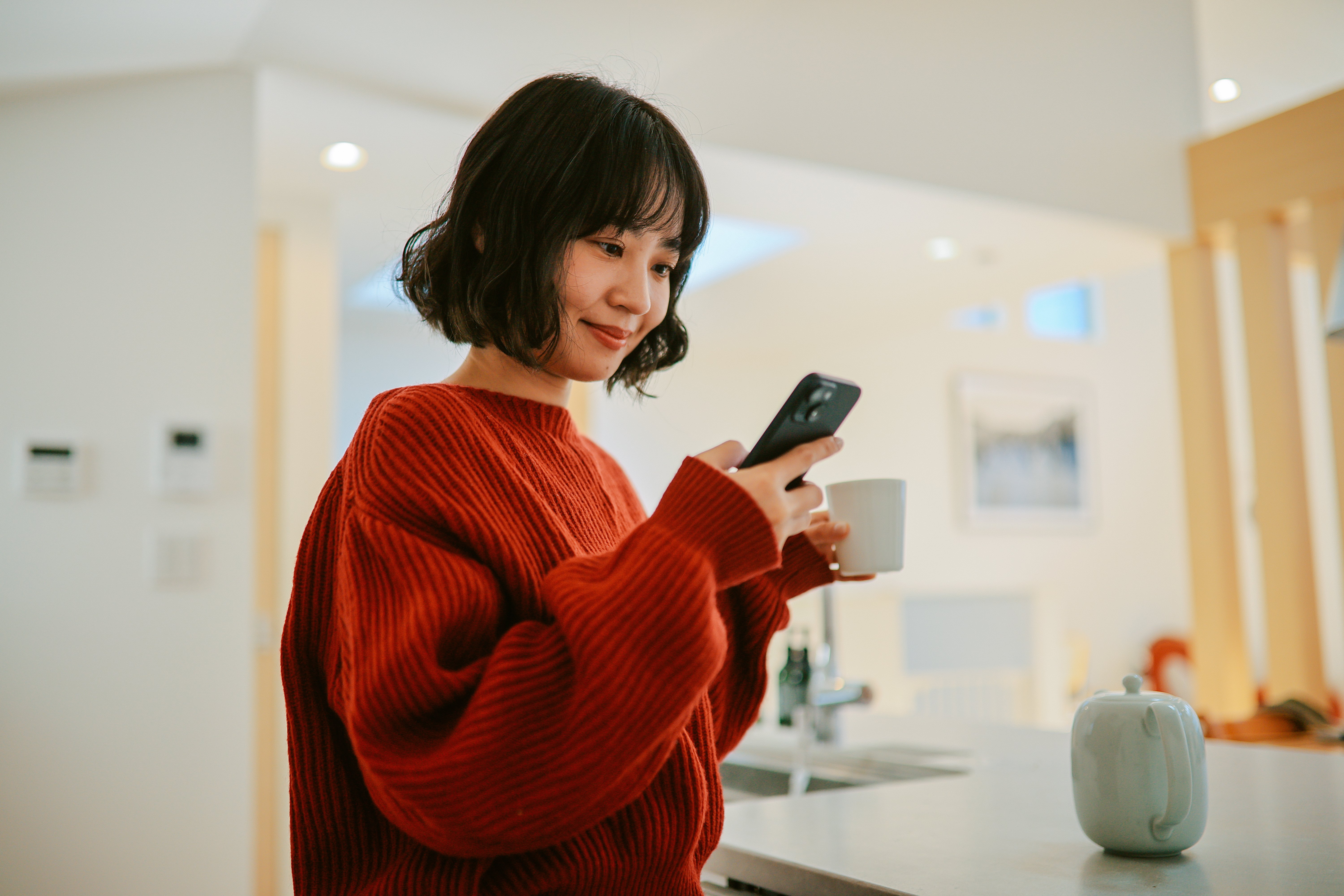 Young 20-something year old woman looking at her phone